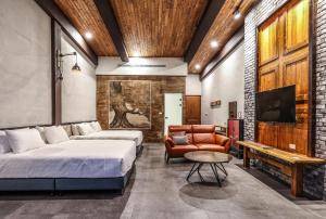 a bedroom with two beds and a couch and a table at Muliu BNB in Xiaoliuqiu