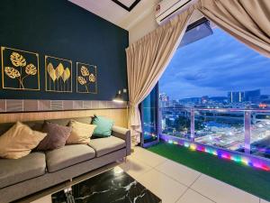 a living room with a couch and a large window at KL One Residence by Nest Home [Infinity Pool & KL Skyline] in Kuala Lumpur