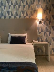 Postel nebo postele na pokoji v ubytování Ouril Hotel Julia