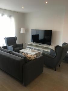 A television and/or entertainment centre at Duna Beach - Infinity Pool