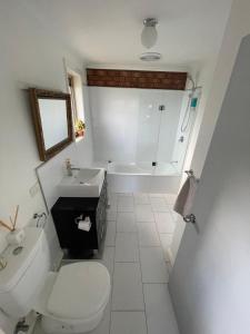 a bathroom with a toilet and a sink and a tub at Beach Haven - Beach and Cafes on your doorstep - 3 bedrooms , Sleeps 6 in Saint Leonards