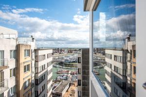 a view of a harbor from a window of a building at nominoé 9e étage in Blankenberge +2 photos