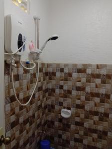 a shower with a hair dryer in a bathroom at KIMURA PENSION in El Nido