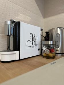 a box sitting on a counter next to a coffee maker at ESI Apartments #Central in Timişoara
