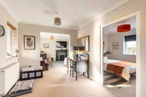 a bedroom with a bed and a desk in a room at Willow Lodge, Wolfscastle in Haverfordwest