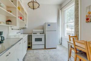 a kitchen with a white refrigerator and a window at Airy and Bright on Broadway in Nashville