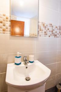 a bathroom with a white sink and a mirror at Maria House in Karpathos Town