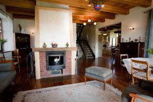 a living room with a fireplace and a couch and a table at Villa Kuligi in Kuligi
