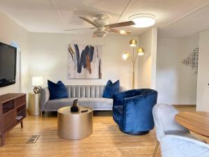 a living room with a couch and a tv at Harmonious Suites in North Miami Beach