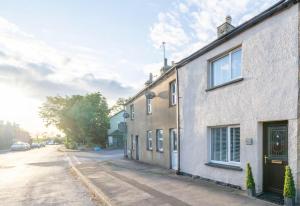 a street view of a house on a street at Cosy Cumbrian cottage for your country escape in Brough