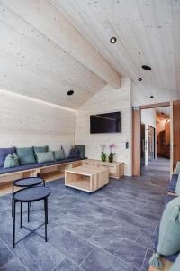 a living room with a couch and a tv at Frühstückspension Sonnblick in Stuben am Arlberg
