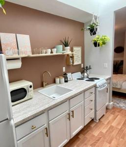 a kitchen with a sink and a microwave at Everything you could ask for in a Rental in Nashville