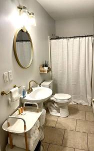 a bathroom with a sink and a toilet and a mirror at Great Apartment in WeHo in Nashville