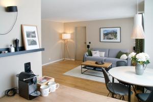 a living room with a couch and a table at Sonnige Panorama Aussicht bei Davos Lenzerheide in Schmitten