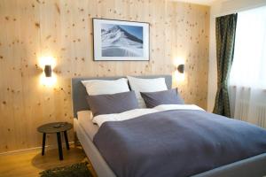 a bedroom with a bed and a snow covered wall at Sonnige Panorama Aussicht bei Davos Lenzerheide in Schmitten +37 photos