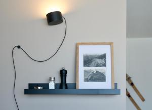 a lamp on a wall with a blue shelf at Sonnige Panorama Aussicht bei Davos Lenzerheide in Schmitten