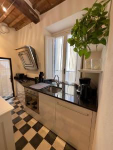 a kitchen with a sink and a counter top at Appartamento Loreto in Lucca