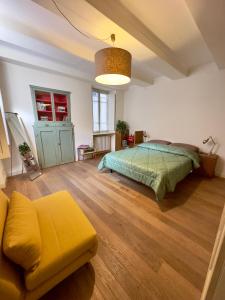 a bedroom with a bed and a couch in it at Appartamento Loreto in Lucca