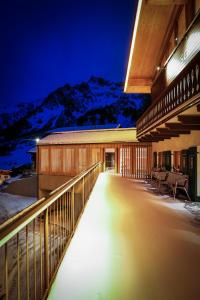 a building with a balcony with a mountain in the background at Chalet Sonnblick in Stuben am Arlberg