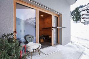 a door to a house with snow on the porch at Chalet Sonnblick in Stuben am Arlberg