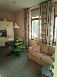 a living room with a couch and a table at zur Friedrichsruh in Oelsnitz/Vogtland