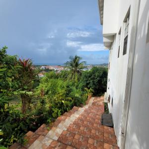 a brick walkway next to a white building at 1 Bed Apt overlooking Rodney Bay in Gros Islet
