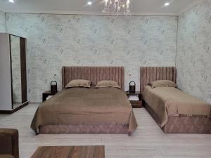 Martuni的住宿－Ahana Hotel in Martuni，一间卧室配有两张床和吊灯。