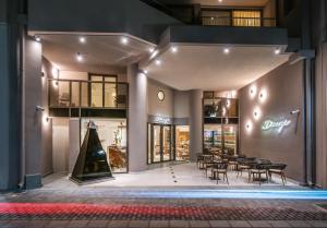 a store front at night with tables and chairs at Dimargio Luxury Hotel & Spa in Heraklio Town