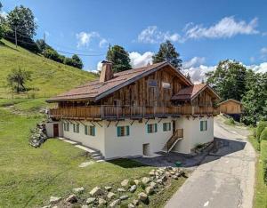 a house with a wooden roof on a hill at Chalet de L'Ours Blanc in Saint-Gervais-les-Bains