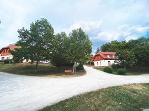 a road leading to a house with trees and a bench at Thermal Valley Apartman - Batthyány Villapark in Zalacsány