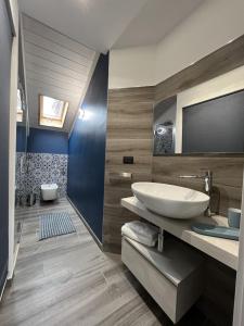 a bathroom with a sink and a mirror at Family Inn in San Maurizio Canavese