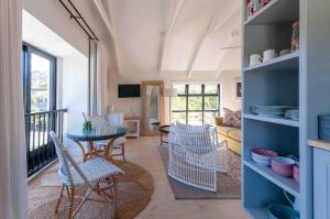 a living room with a table and chairs at African Flame Apartment in Knysna