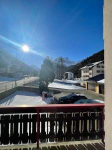 a view from a balcony with snow on the roof at apartment Alpenrose in Saas-Grund