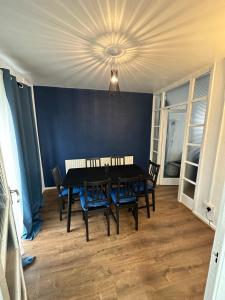 a dining room with a black table and chairs at Lovely Spacious 3 bedrooms house in Kingshurst