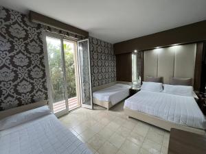 Postel nebo postele na pokoji v ubytování Hotel Lafayette
