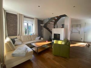 a living room with a couch and a staircase at Casa Manfredi in Prerow