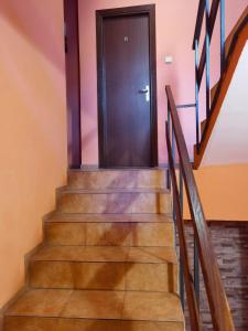 a staircase with a black door in a house at House for Guests and Friends in Svishtov