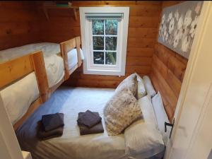 a room with two bunk beds and a window at Great Escapes,Rhinog mountain View in Trawsfynydd