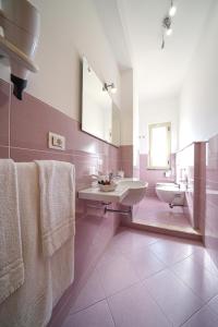 a bathroom with a sink and a mirror at Hotel Damanse in Santa Domenica