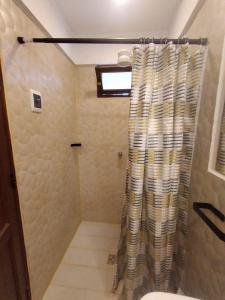 a bathroom with a shower with a shower curtain at Como en Casa Torotoro in Torotoro