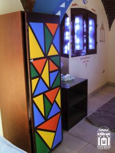 Kato Waidi Nubian Resort في أسوان: باب زجاجي ملون في غرفة مع منضدة