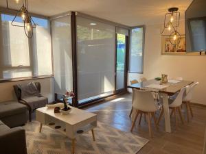 a living room with a table and a dining room at Puerto Montt apartamento 1 en playa Pelluco in Puerto Montt +4 photos