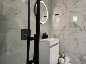 a bathroom with a sink and a mirror at Sea View Loft in Nea Roda