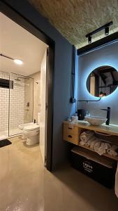 a bathroom with a sink and a toilet and a mirror at Cocoloft de Diseño in Buenos Aires
