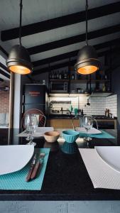a kitchen with a table with two chairs and two lights at Cocoloft de Diseño in Buenos Aires
