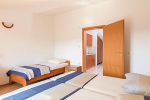 a room with two beds and a door to a bedroom at Villa Marcelina in Seget Vranjica