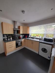 a kitchen with a sink and a stove top oven at Fonn Na Mara in Campbeltown