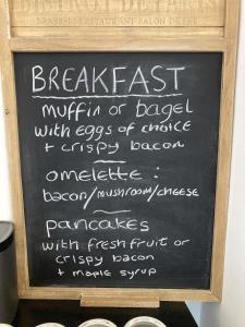 a chalkboard sign with the words breakfast on it at Summer Breeze Guest House in Newquay