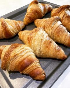 a tray of croissants sitting on a table at Summer Breeze Guest House in Newquay +15 photos