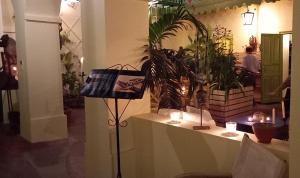 a shop with a floor lamp with candles and plants at La Maison du Marin in Gorée